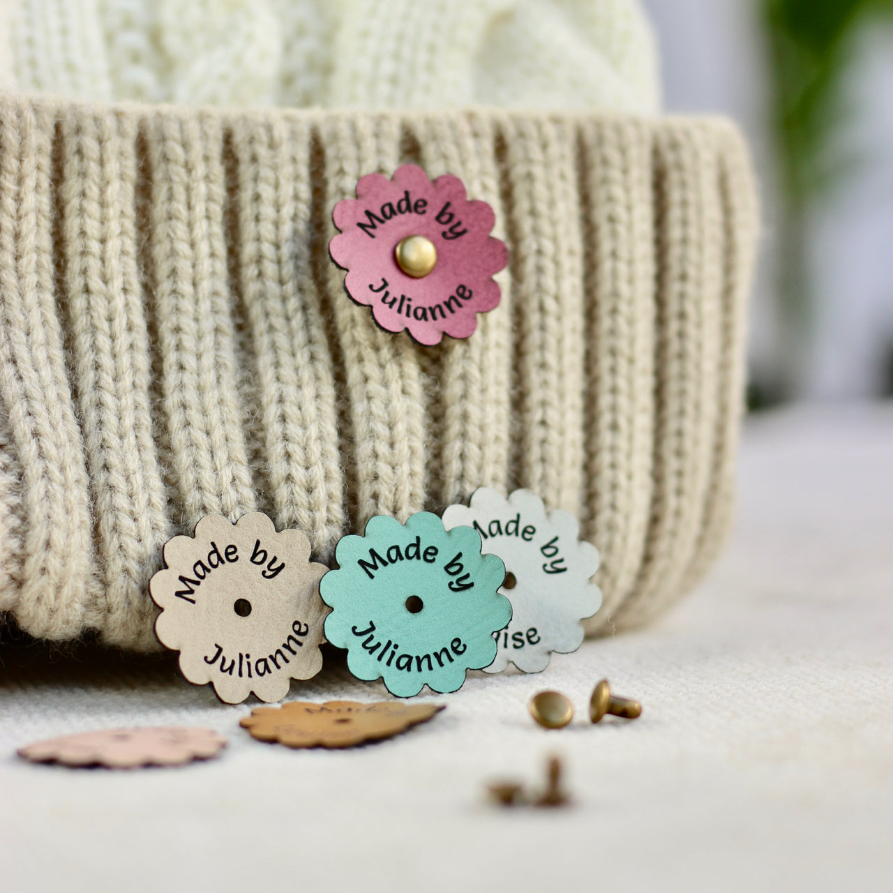 Colorful 'Made by Julianne' labels on a textured surface with a blurred background