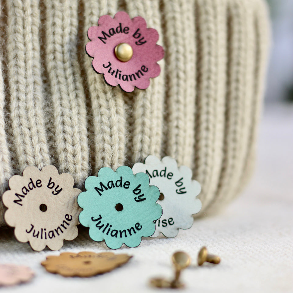Colorful 'Made by Julianne' labels on a textured surface with a blurred background