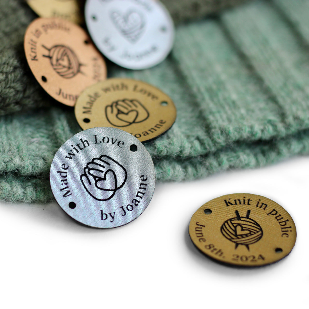 Close-up of round custom name or logo tag in metallic colors