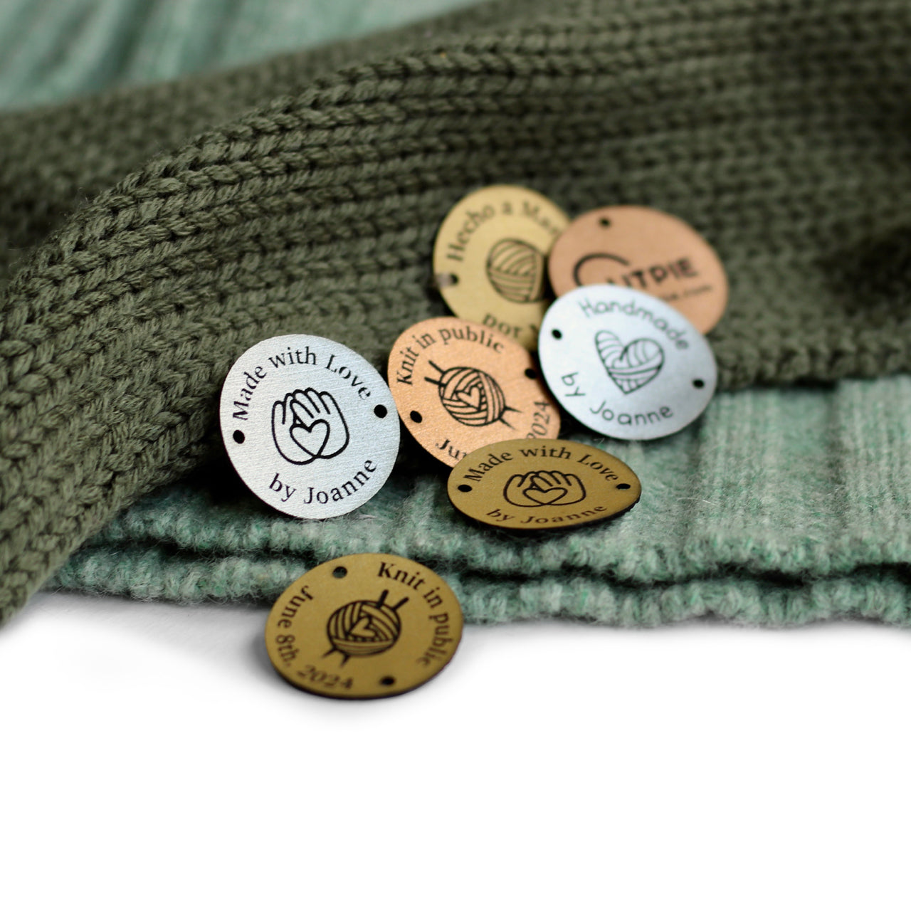 Collection of round custom name or logo tags in copper, gold, and silver