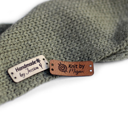 Personalized knitting leather tag in a mix of ivory, brick, and coffee hand sewn on a knitted fabric.