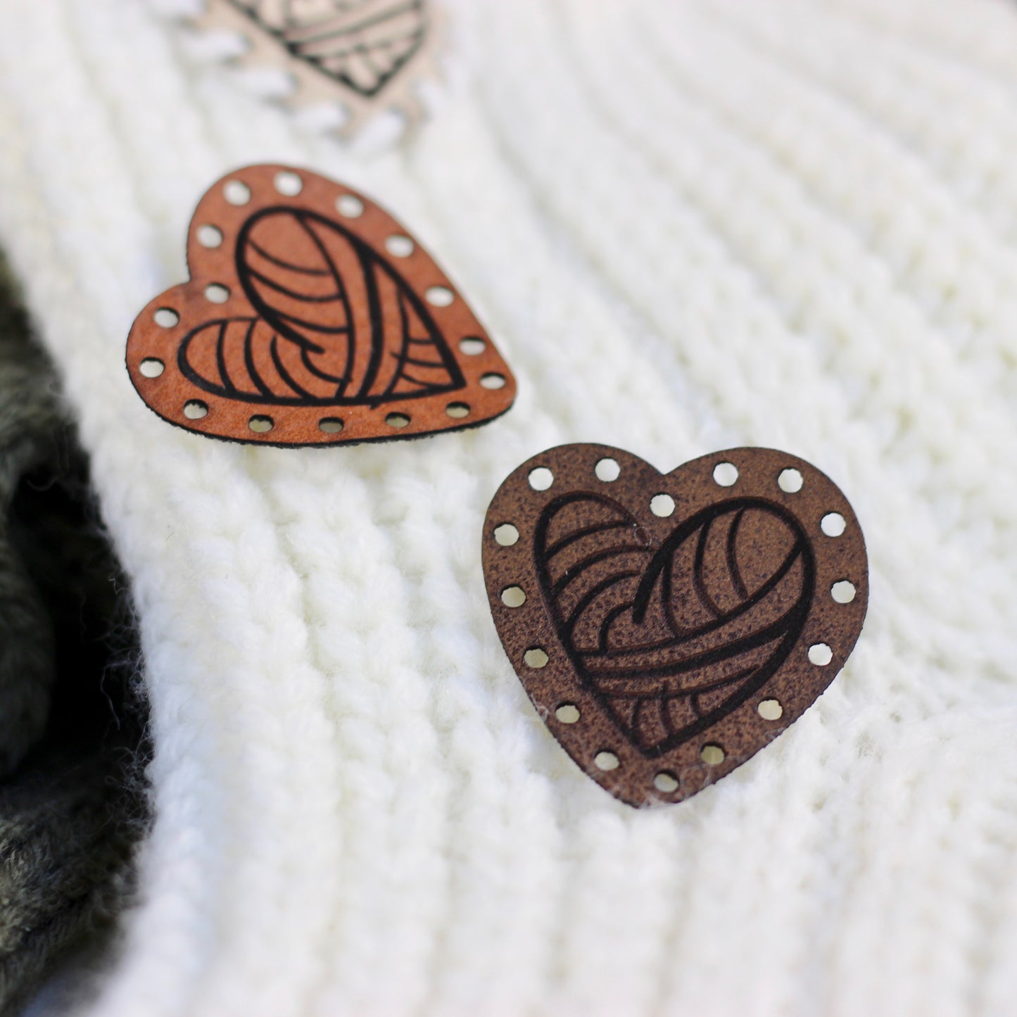 Brown heart shape tag on a knitting project.