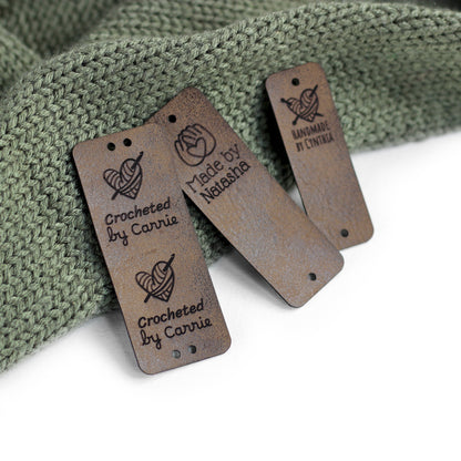 Tags for knits in coffee color on a textured fabric.