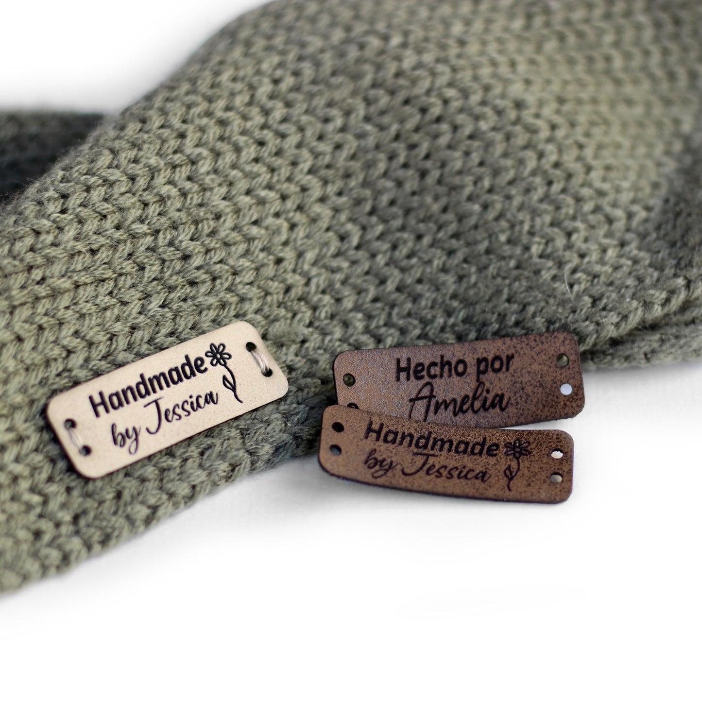 Personalized knitting leather tag in a mix of ivory, brick, and coffee hand sewn on a knitted fabric.