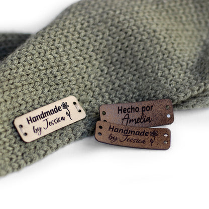 Personalized knitting leather tag in a mix of ivory, brick, and coffee hand sewn on a knitted fabric.