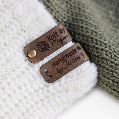 Folded tags attached to a knitted fabric with bronze rivets