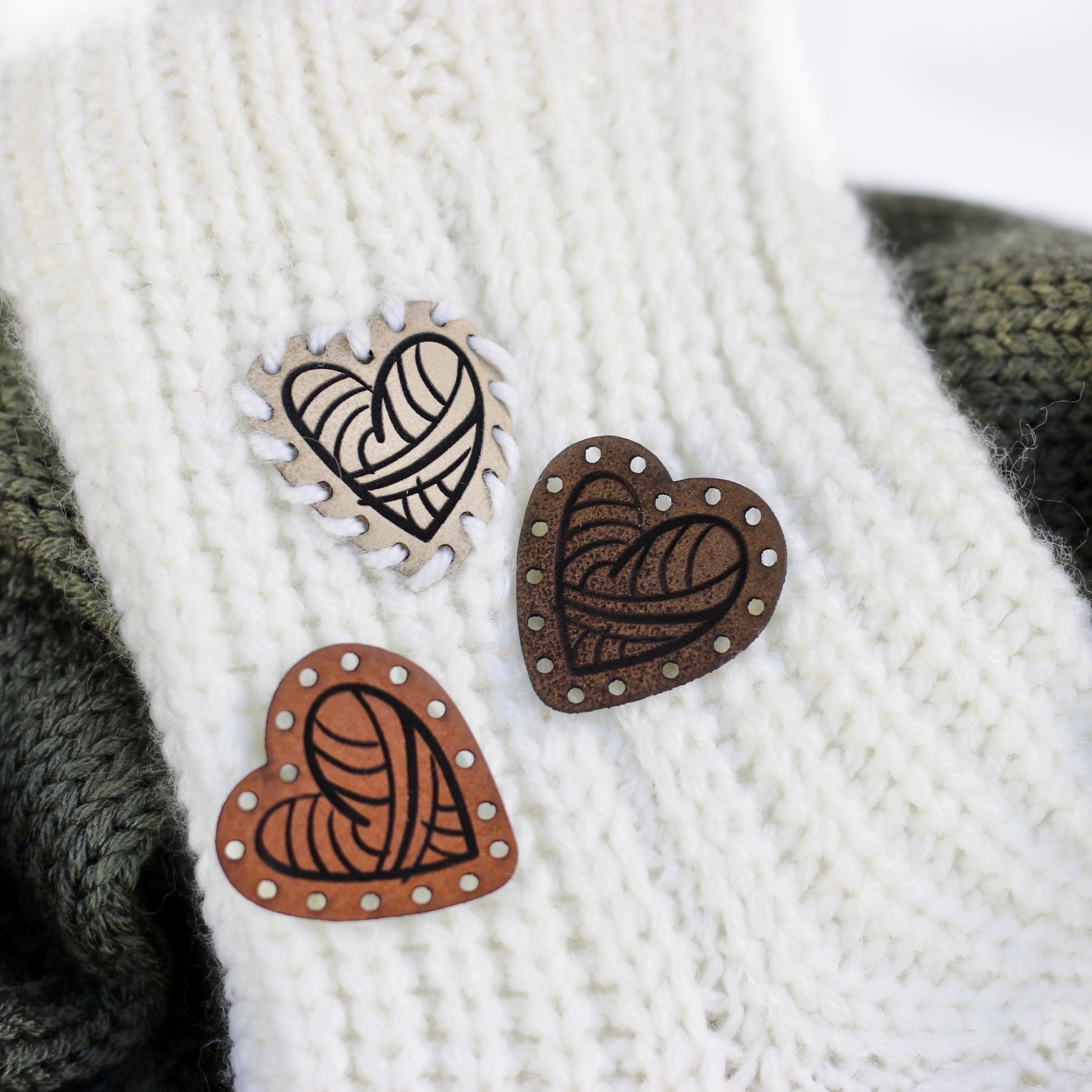 Heart shape tag for knitting projects on a knitted item.