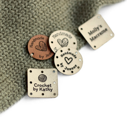 Ivory knitting tags for custom names attached to a knitted item.