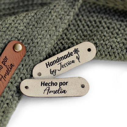 Off white color tags for knitting, perfect for customization, attached with rivets on both ends.