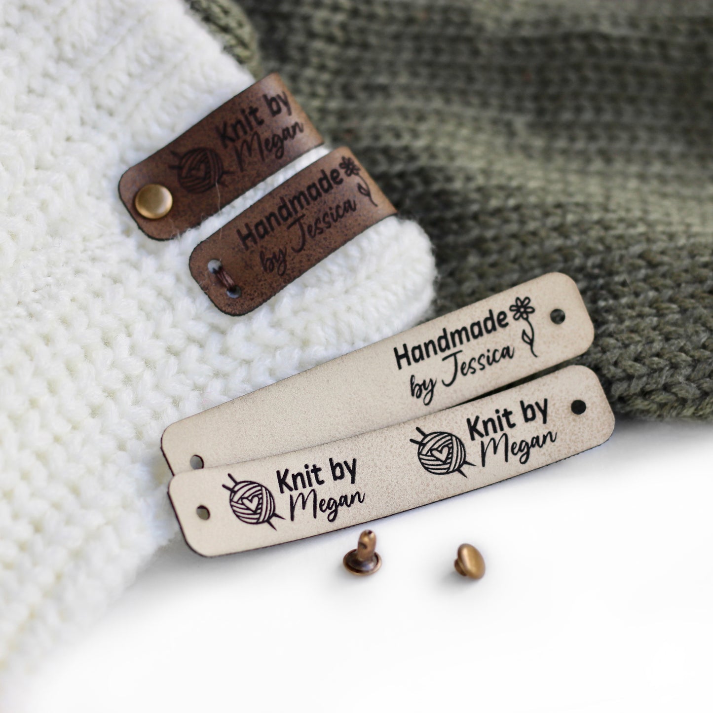 Folded tags attached to a knitted fabric with bronze rivets in offwhite faux leather