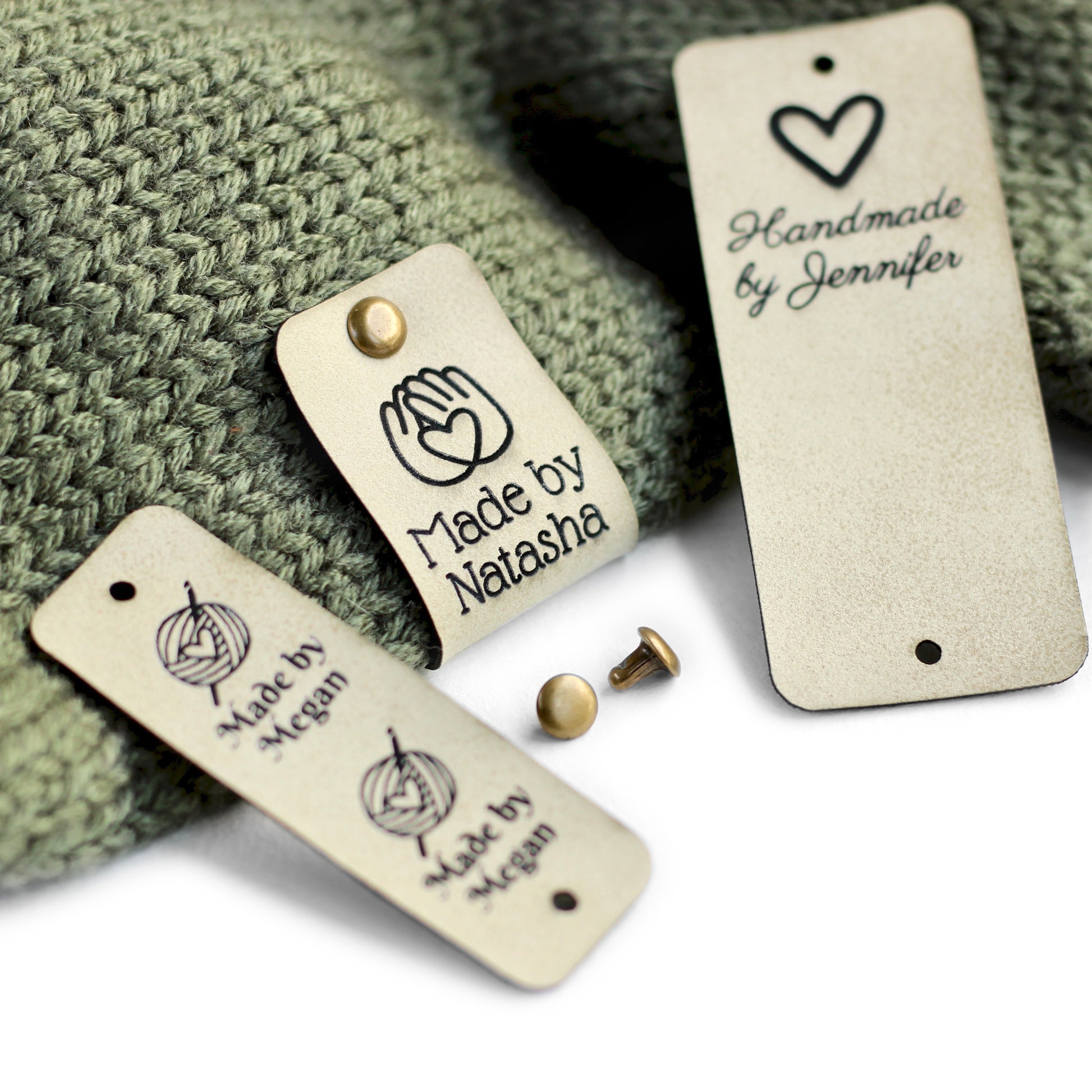 Crochet labels in cream attached to a knitted piece.